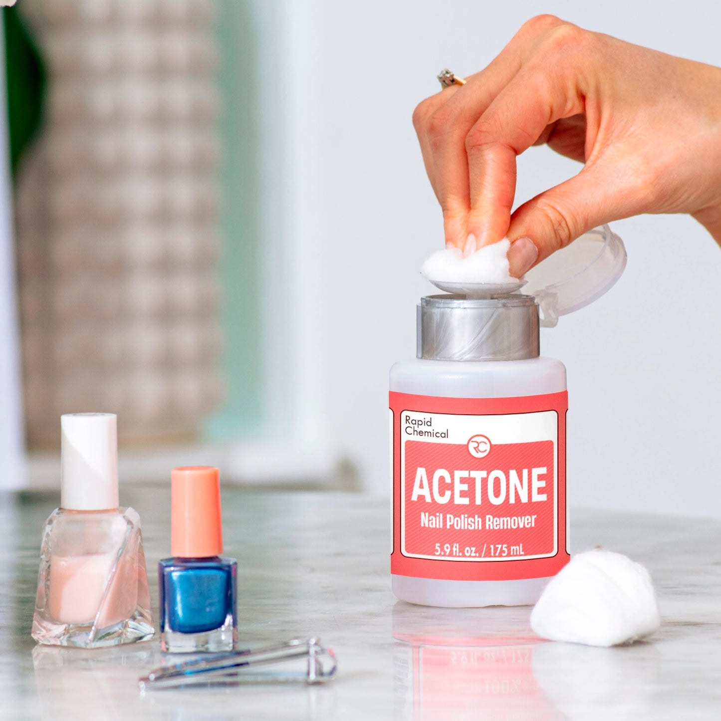 Using Rapid Chemical acetone nail polish remover with cotton pad for manicure care.